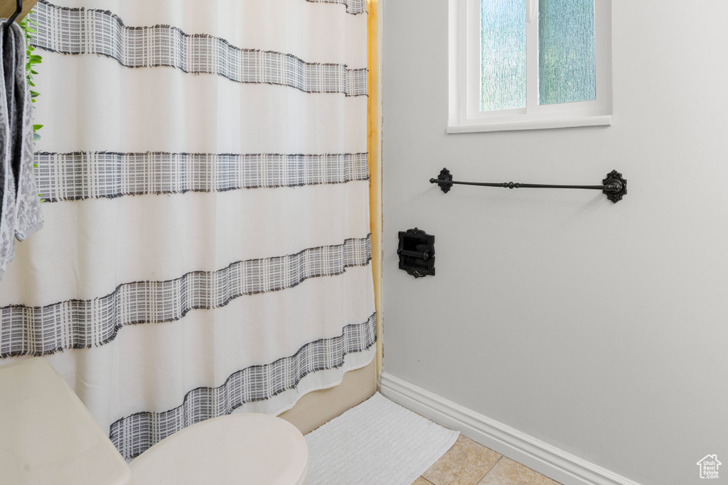 Full bath with tile patterned flooring and curtained shower
