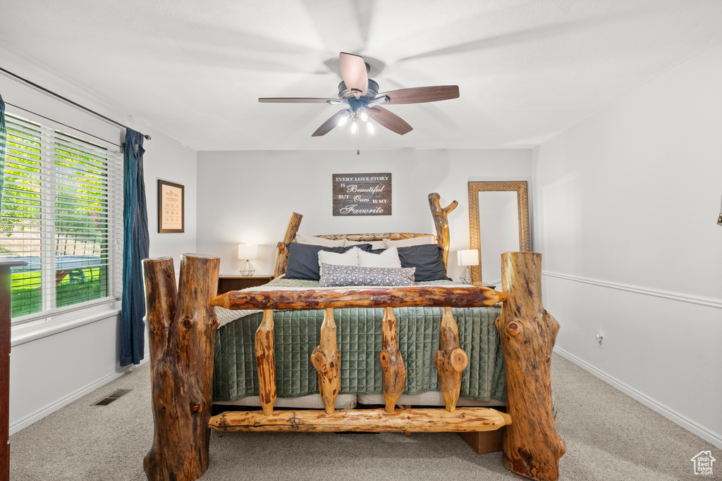 Carpeted bedroom with baseboards and a ceiling fan