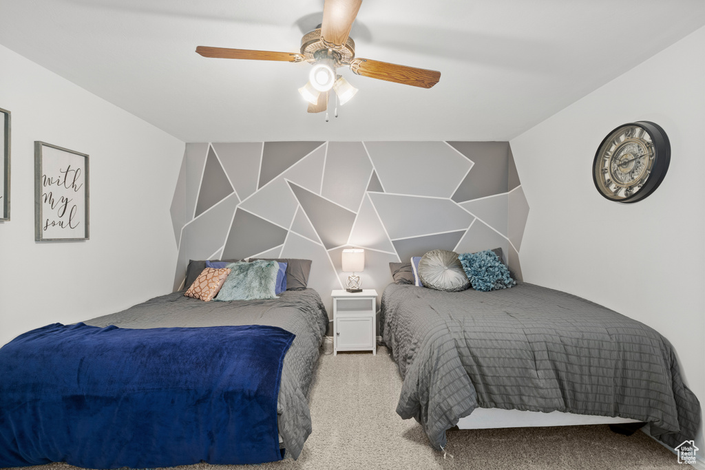 Bedroom with a ceiling fan and carpet flooring