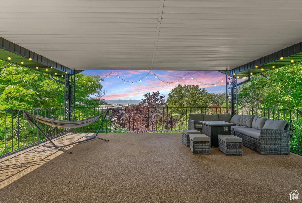 Patio terrace at dusk with an outdoor hangout area and a patio