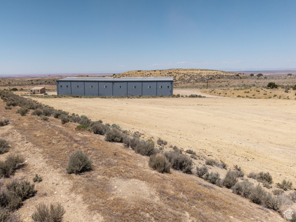 View of yard with a view of countryside, a pole building, and an outdoor structure