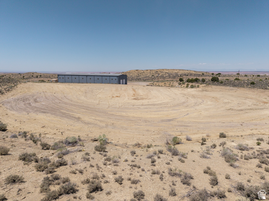 View of yard featuring view of desert landscape, a view of countryside, and an outdoor structure