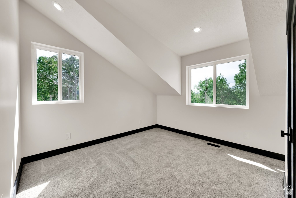Bonus room with carpet, healthy amount of natural light, recessed lighting, and vaulted ceiling