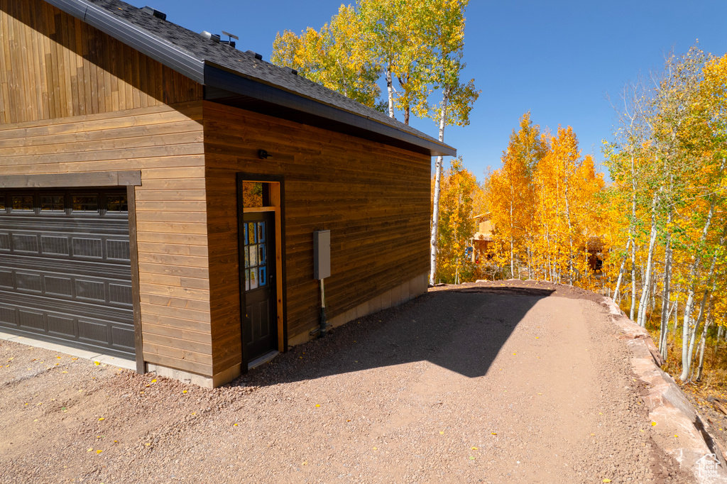 View of side of property with a garage and an outdoor structure