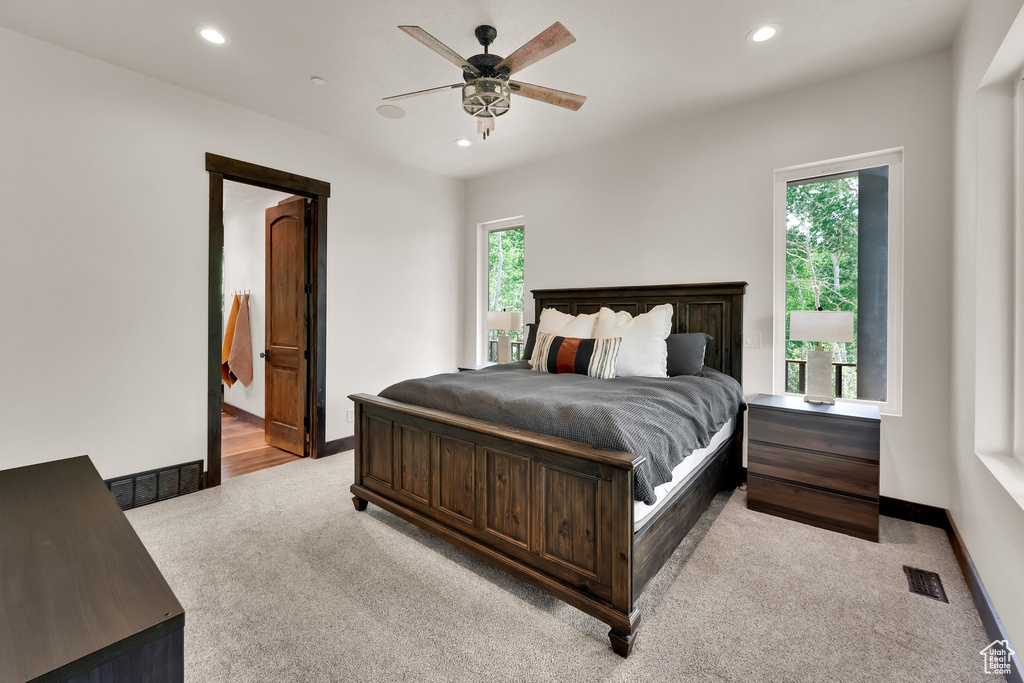 Carpeted bedroom with recessed lighting and a ceiling fan