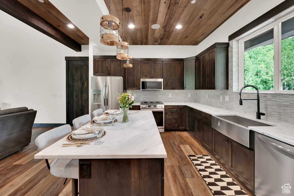 Kitchen featuring appliances with stainless steel finishes, wood ceiling, recessed lighting, dark brown cabinets, and decorative backsplash