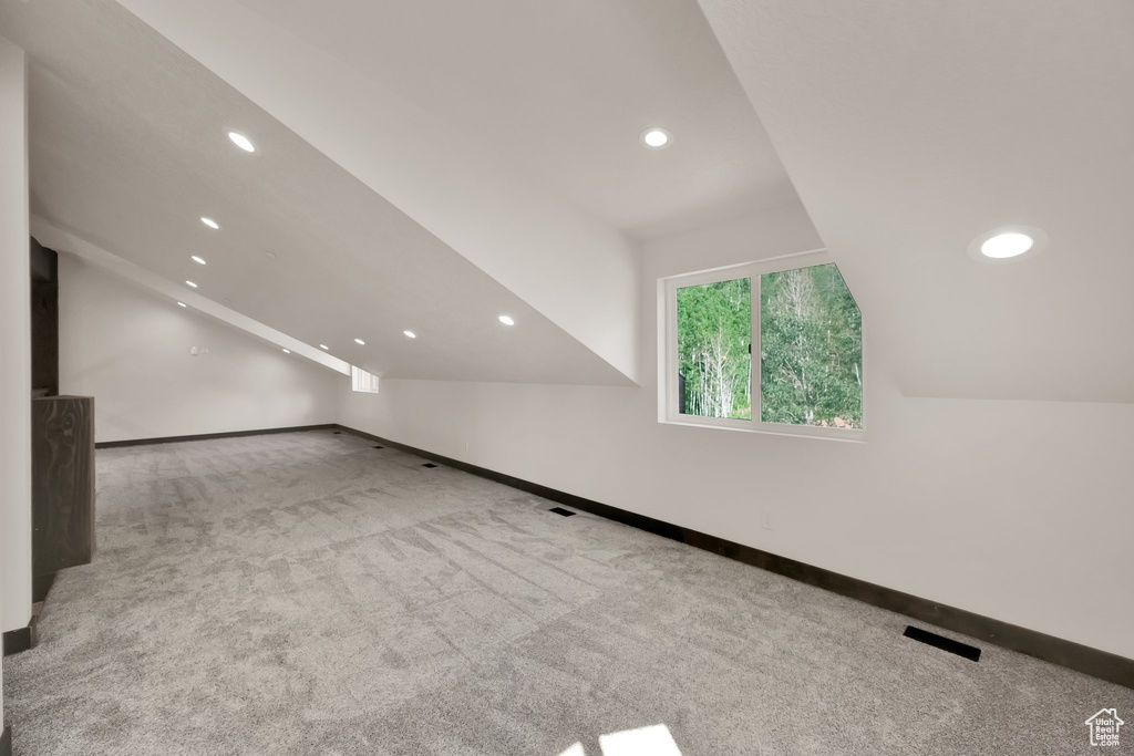 Additional living space featuring carpet, recessed lighting, and vaulted ceiling