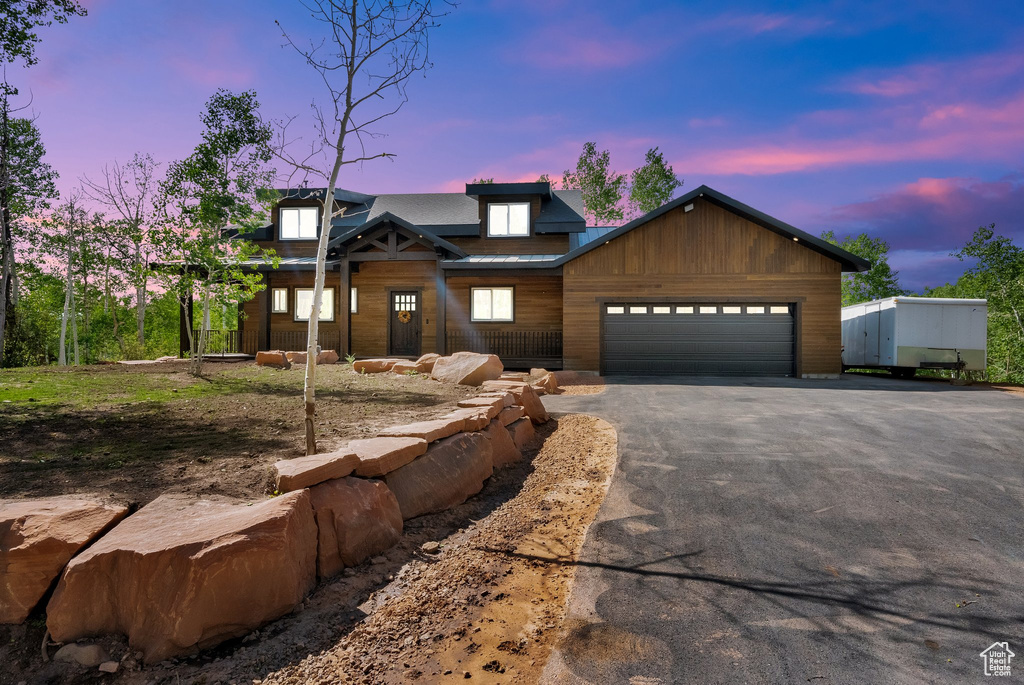 Chalet / cabin with driveway and a garage