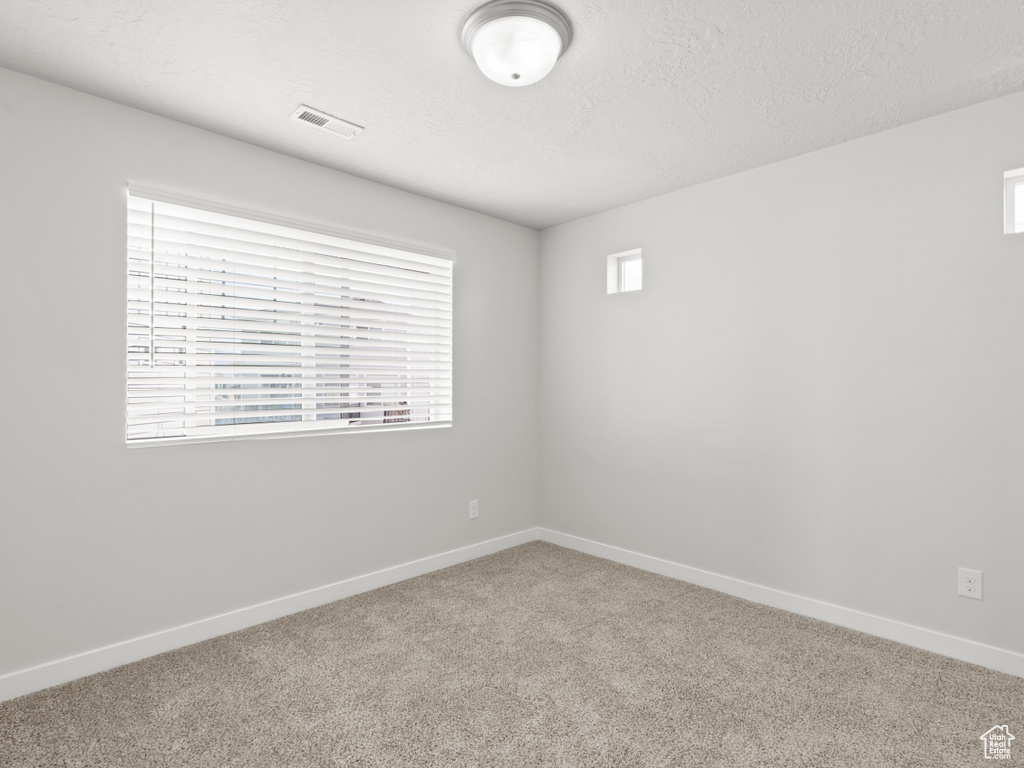 Unfurnished room with carpet floors and baseboards
