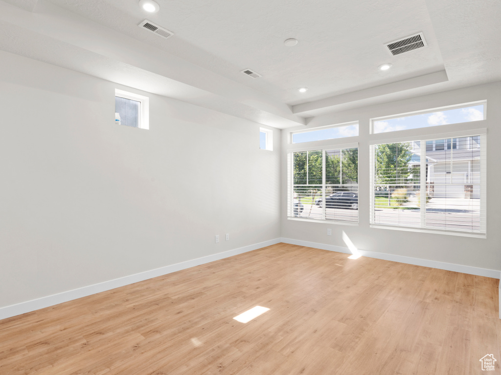 Spare room with light wood-style flooring, plenty of natural light, and recessed lighting