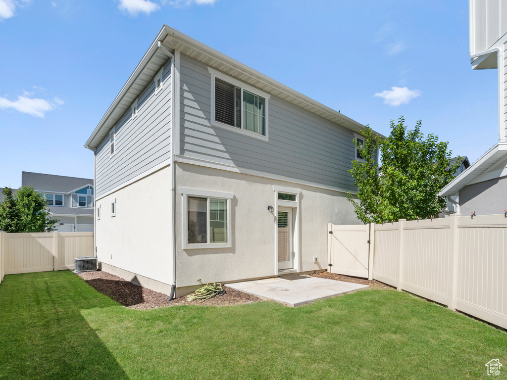 Back of property with a gate, a fenced backyard, a patio area, and stucco siding