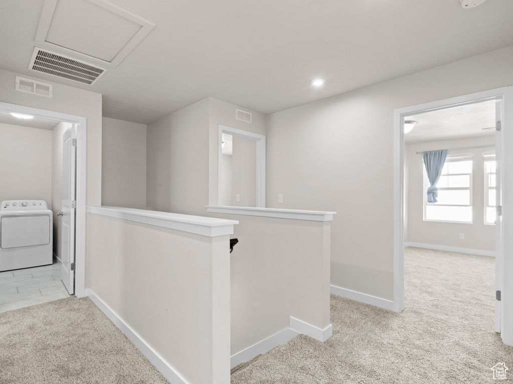 Corridor with washer / dryer, an upstairs landing, light colored carpet, recessed lighting, and attic access