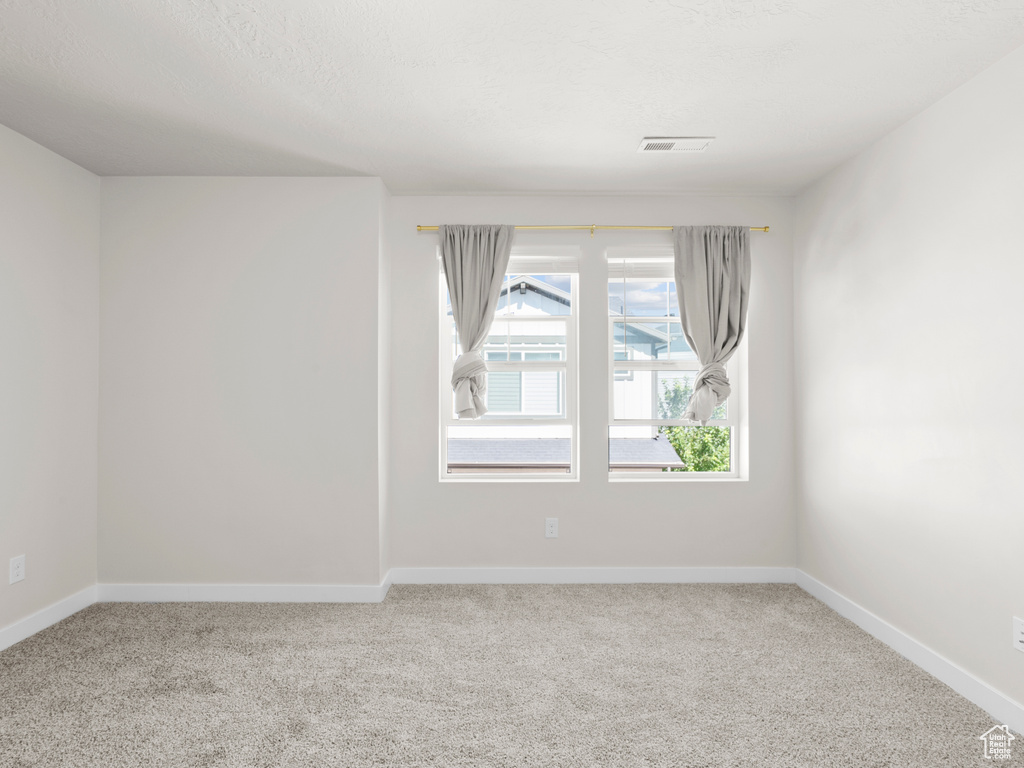 Unfurnished room featuring carpet flooring and baseboards