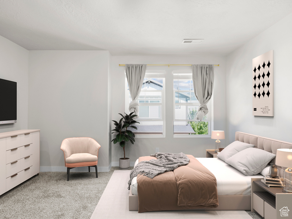 Carpeted bedroom featuring baseboards