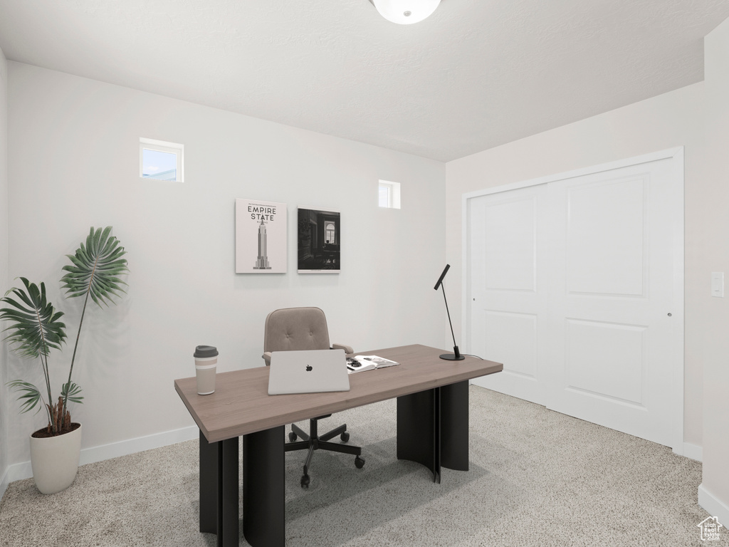 Office space with light colored carpet and healthy amount of natural light