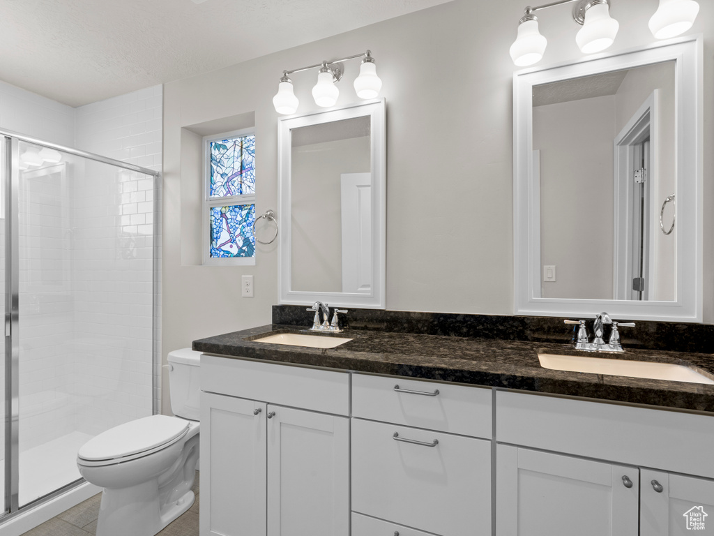 Bathroom with double vanity and a shower stall