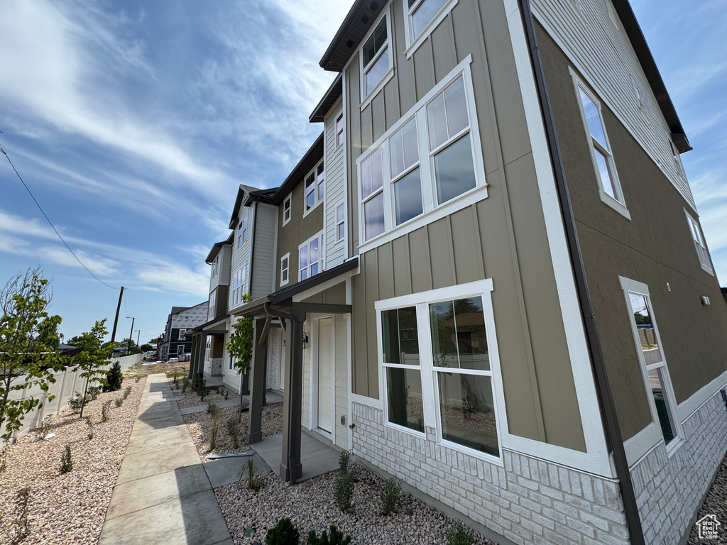 View of home\\\'s exterior featuring board and batten siding and brick siding
