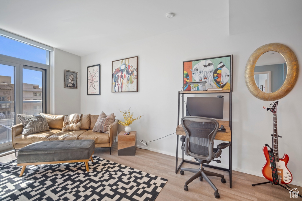 Living area with wood finished floors and a desk