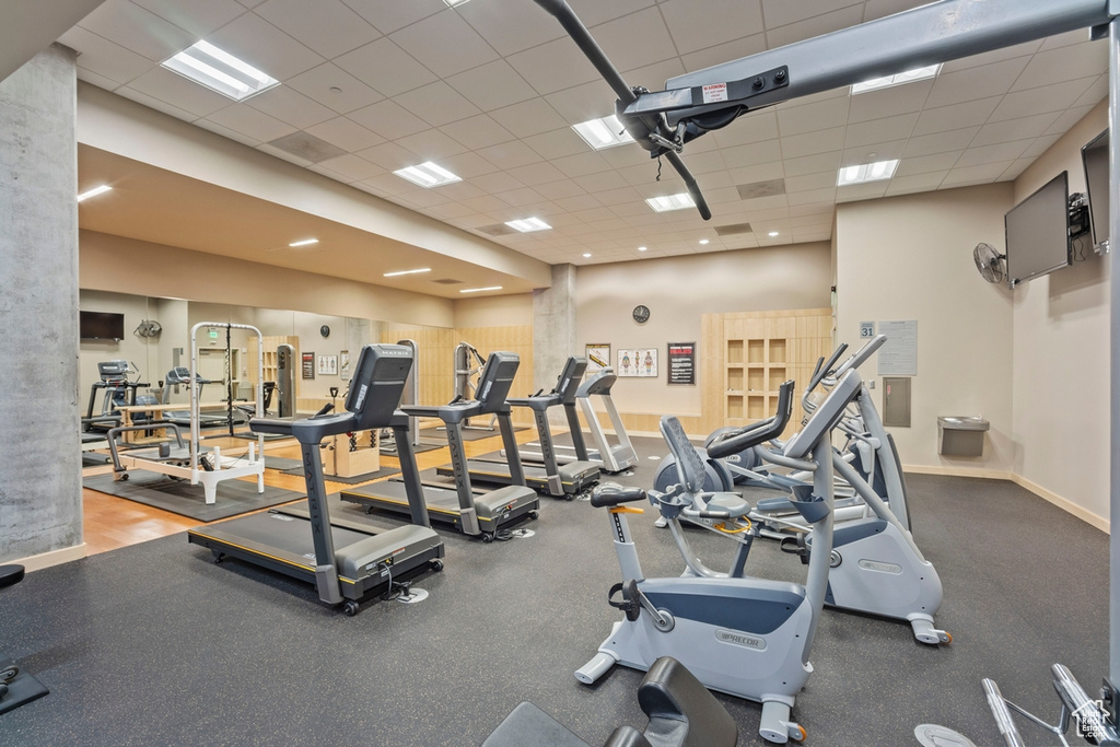 Exercise room featuring a drop ceiling and baseboards