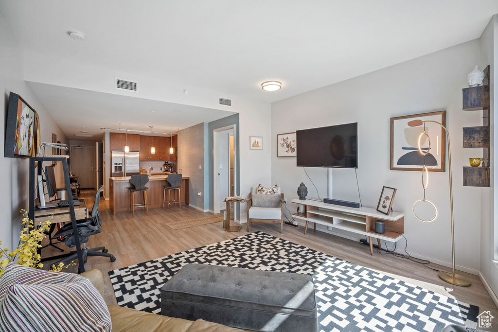Living area featuring light wood-style floors and baseboards