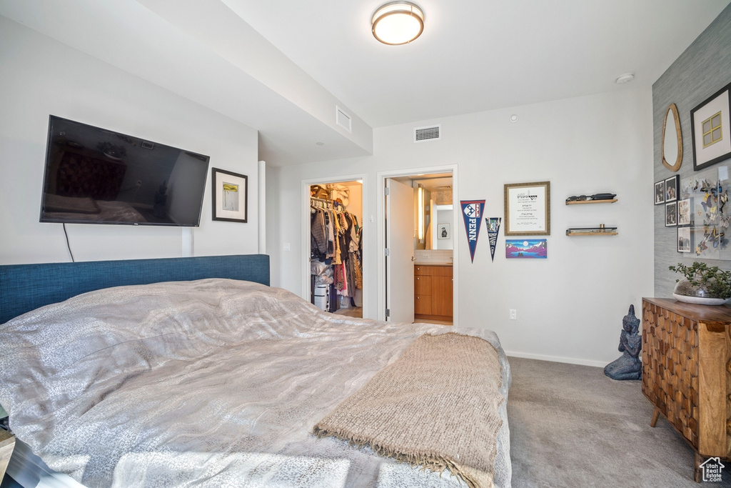 Bedroom with carpet flooring, a spacious closet, and a closet