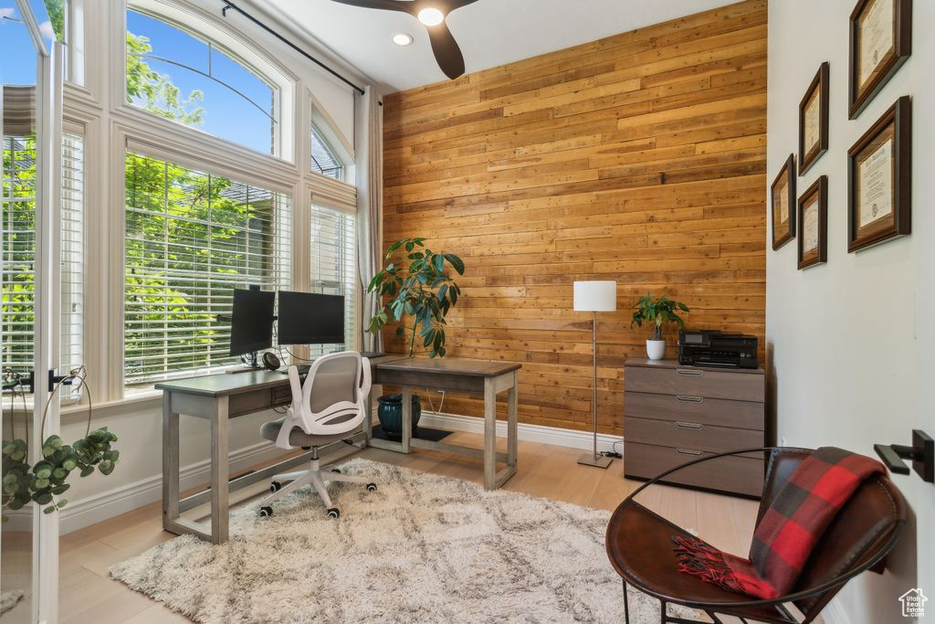 Home office featuring wooden walls, ceiling fan, wood finished floors, and recessed lighting