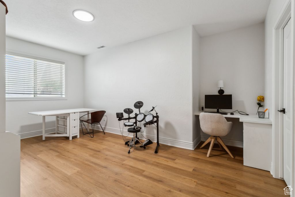 Office space with light wood finished floors and baseboards
