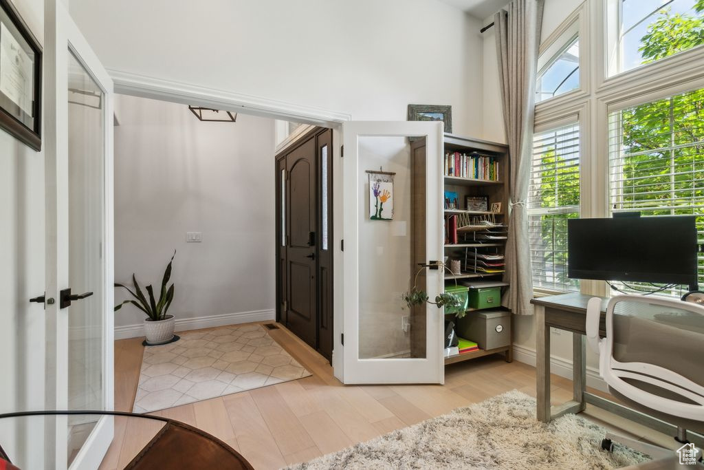 Office featuring french doors, plenty of natural light, and light wood-style flooring