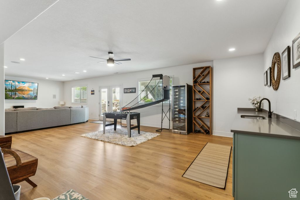 Living area featuring wine cooler, recessed lighting, a ceiling fan, and light wood-type flooring