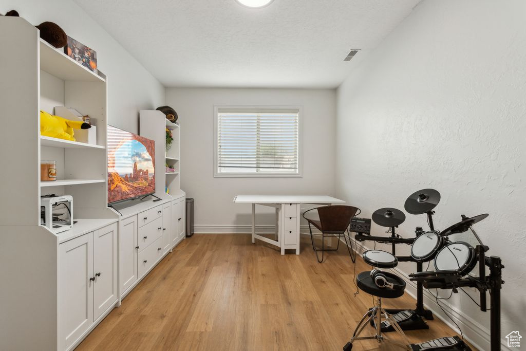 Game room with light wood-style floors and baseboards