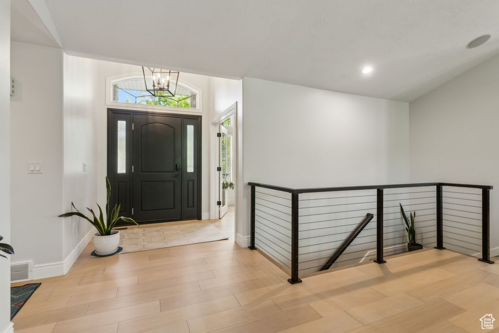 Foyer entrance featuring light wood-type flooring, a chandelier, and recessed lighting