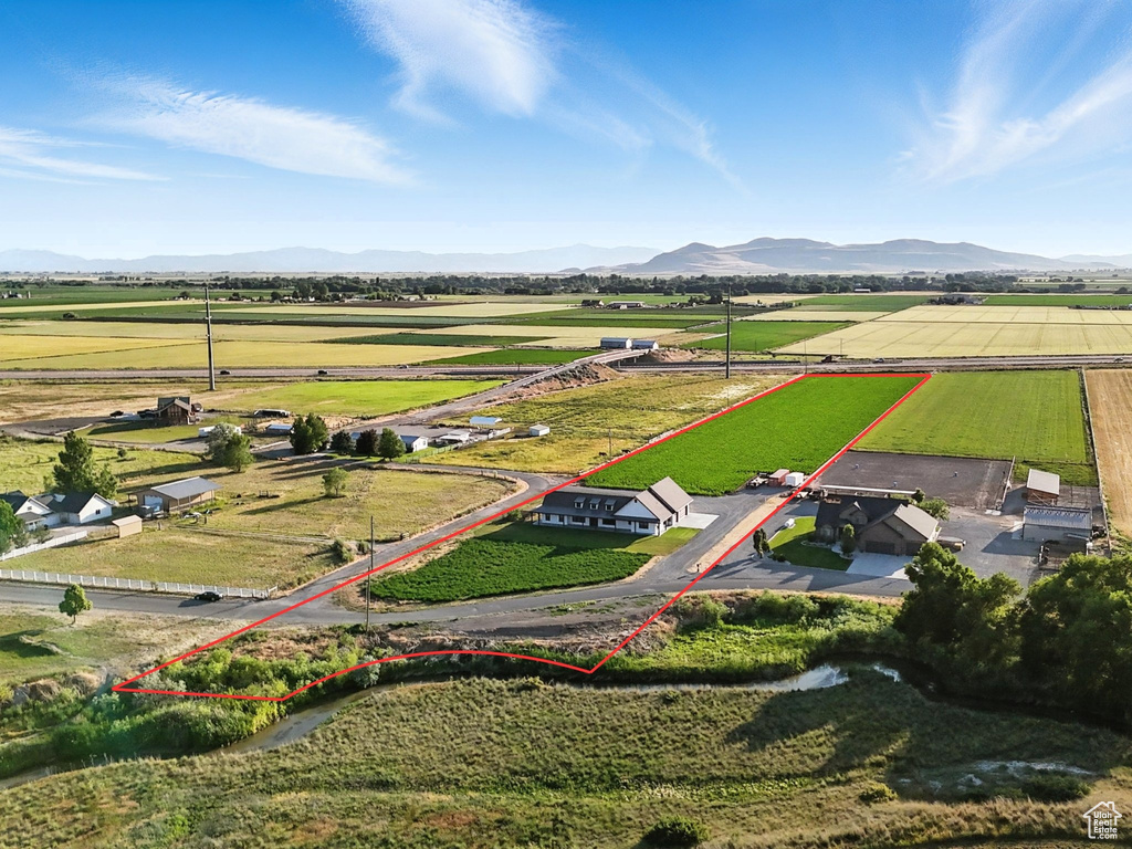Aerial view of sparsely populated area featuring a mountain backdrop and property boundaries highlighted