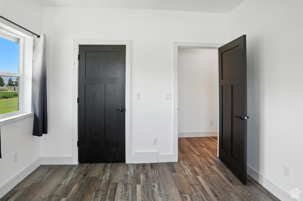 Unfurnished bedroom featuring wood finished floors