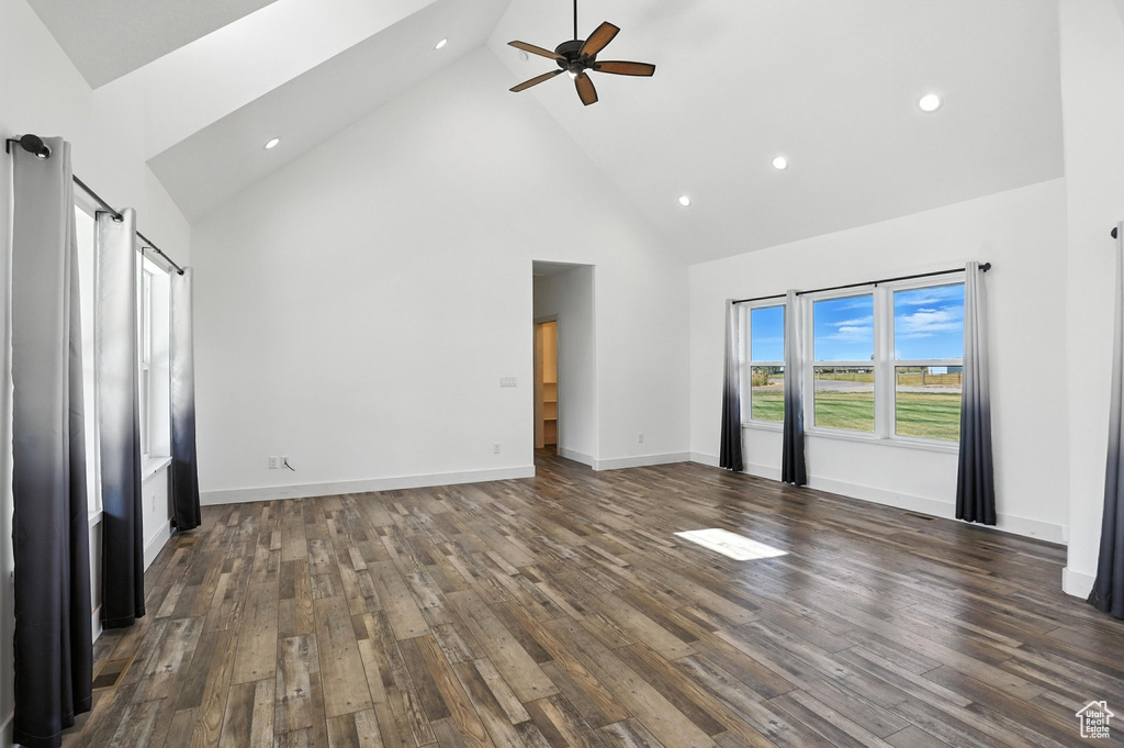 Unfurnished living room featuring high vaulted ceiling, a ceiling fan, dark wood finished floors, and recessed lighting