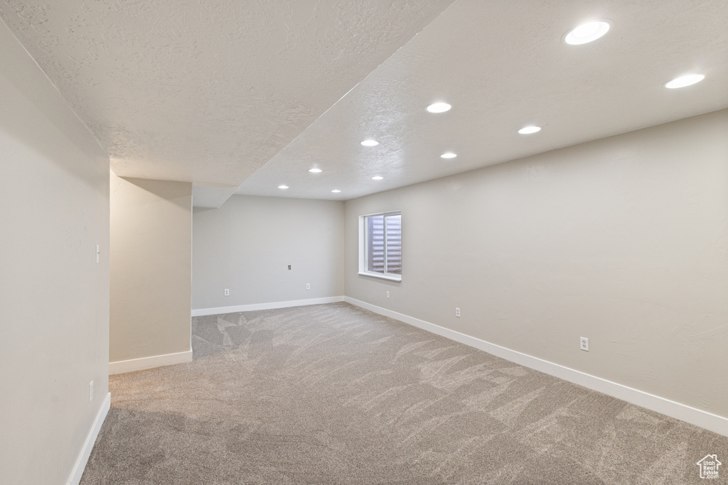 Basement featuring recessed lighting, carpet, and a textured ceiling