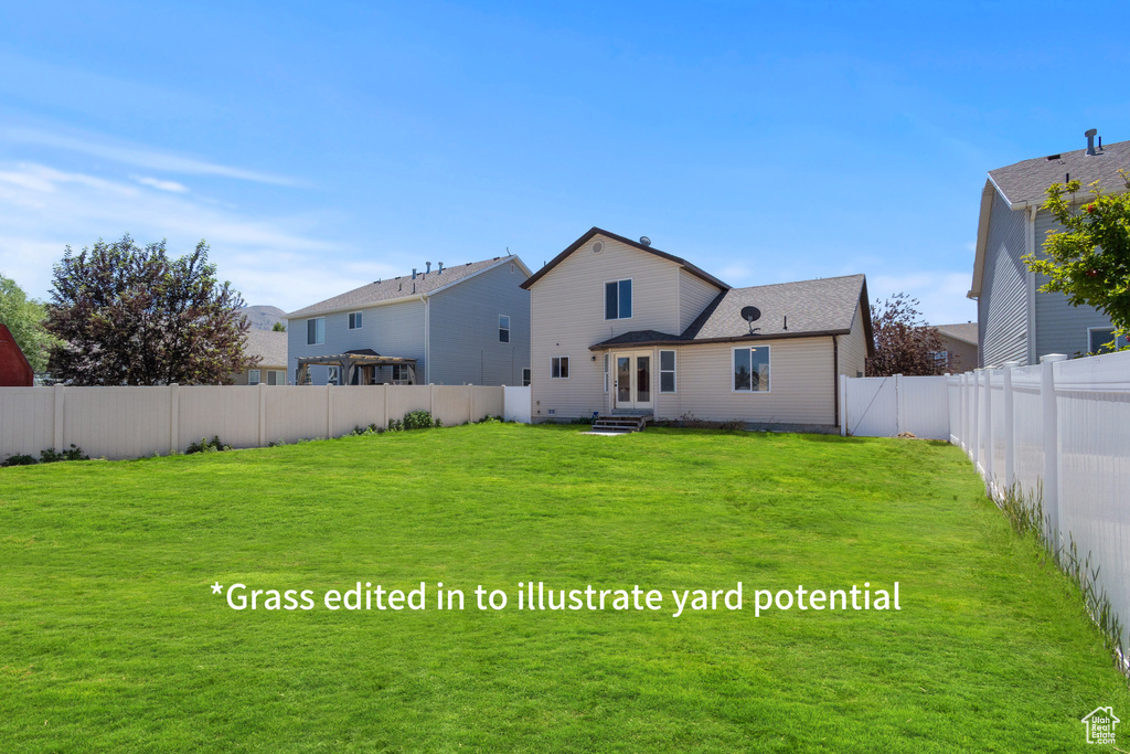 Back of house featuring a fenced backyard