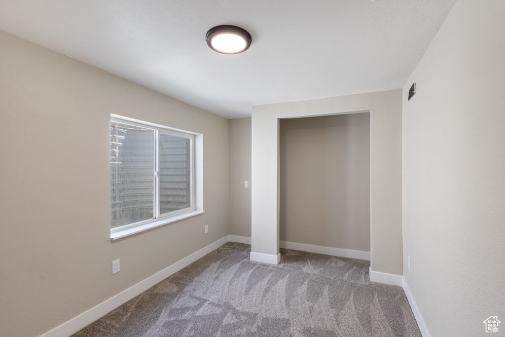 Unfurnished bedroom with carpet and a closet