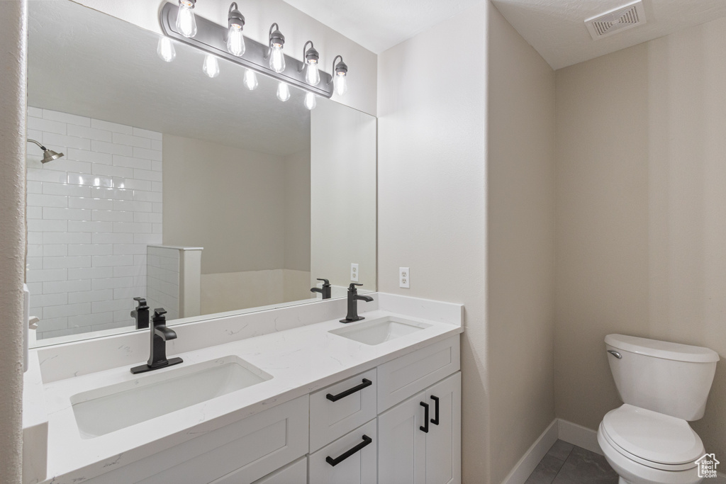 Full bathroom with double vanity and tile patterned floors