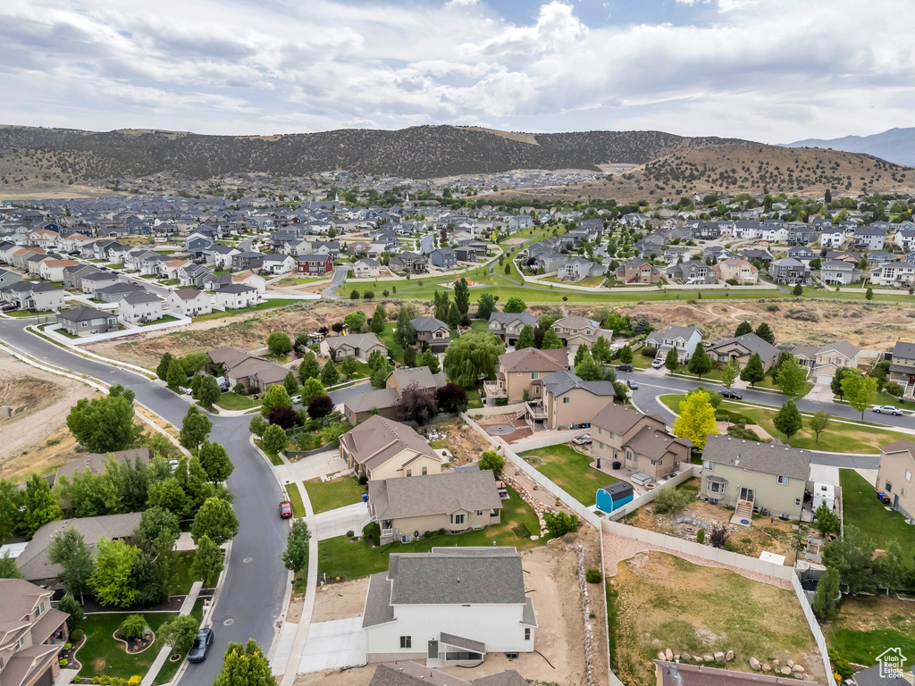 Aerial view of property\'s location featuring nearby suburban area and mountains