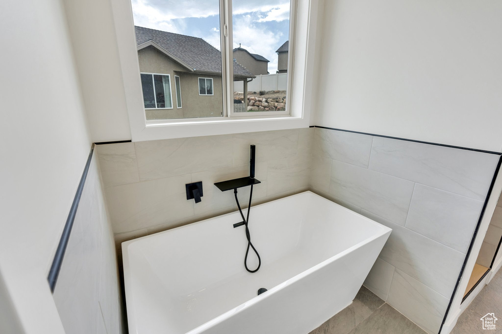 Bathroom with tile walls and a freestanding tub
