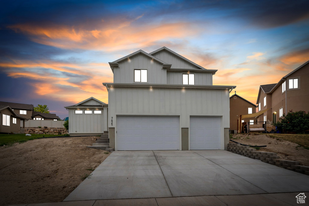 View of front facade with driveway and an attached garage