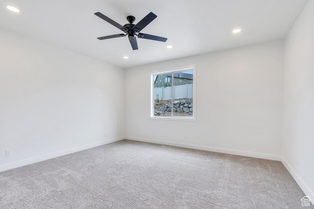 Empty room featuring carpet, recessed lighting, and a ceiling fan