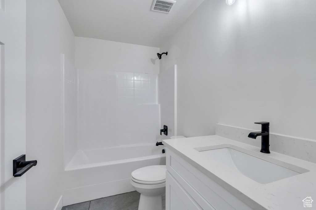 Bathroom with bathing tub / shower combination, vanity, and tile patterned flooring