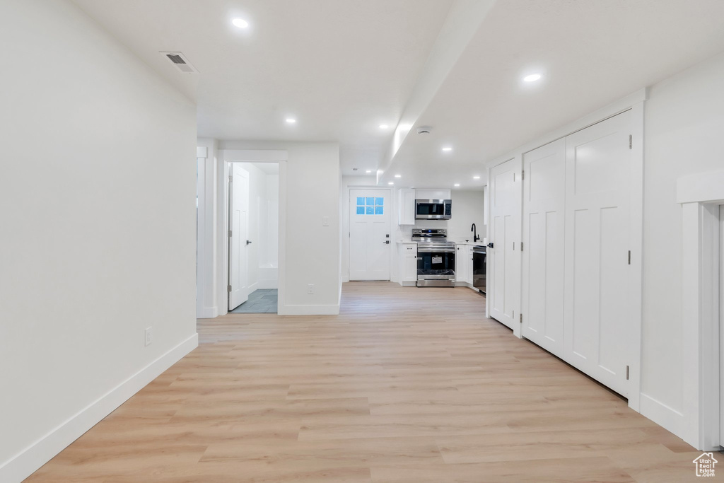 Hall featuring recessed lighting and light wood-type flooring