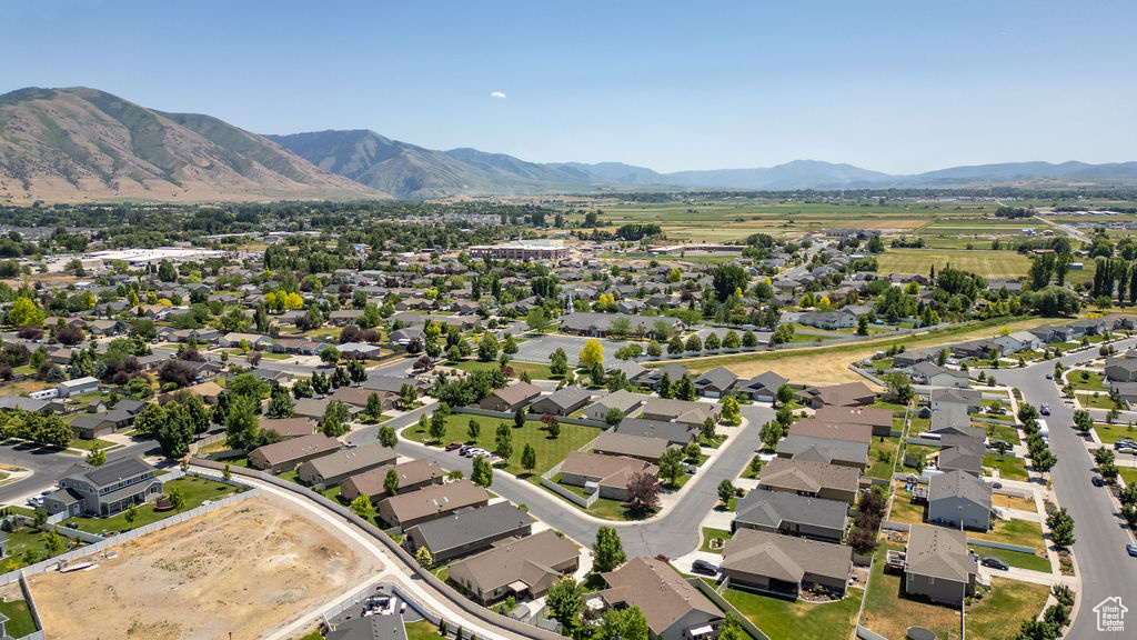 Aerial view of property\'s location with a mountain backdrop and nearby suburban area