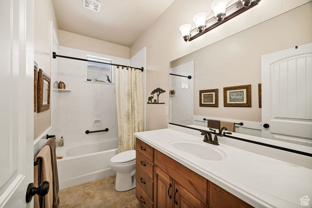 Bathroom featuring vanity and shower / bath combo