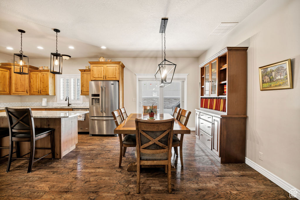 Dining room featuring recessed lighting and dark wood-style flooring