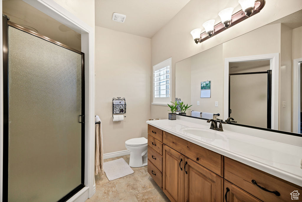 Full bathroom featuring vanity and a shower stall
