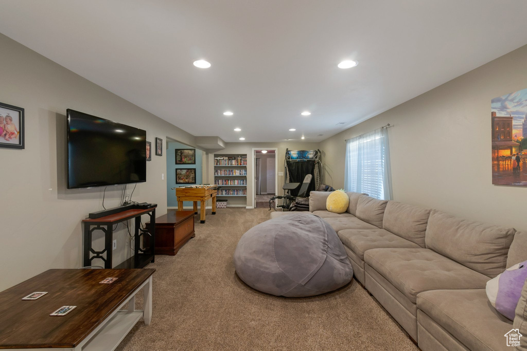 Living area featuring light carpet and recessed lighting