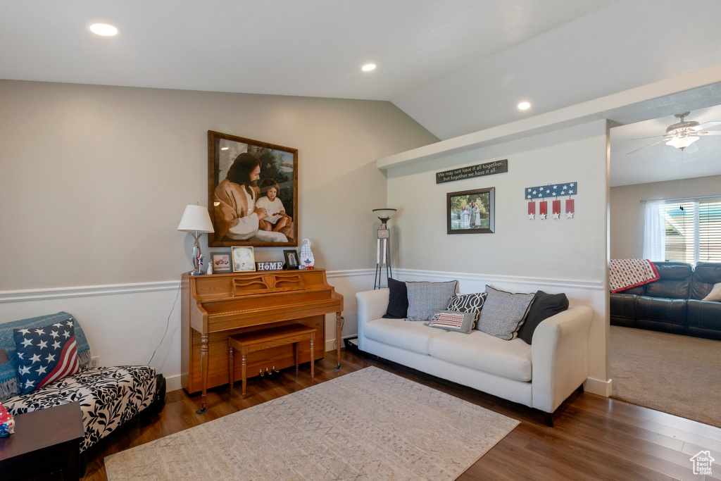 Living area with wood finished floors, ceiling fan, vaulted ceiling, and recessed lighting